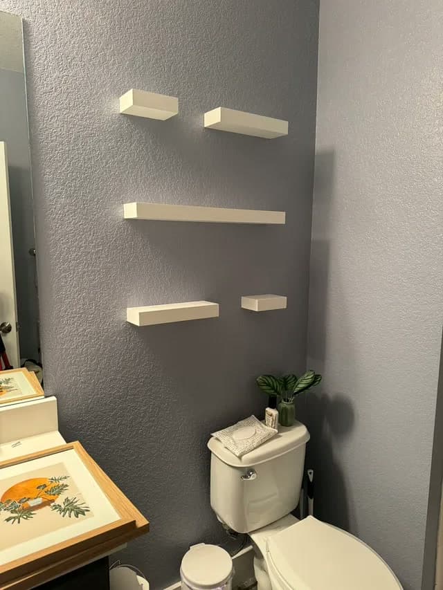 Floating shelves on a bathroom wall — after