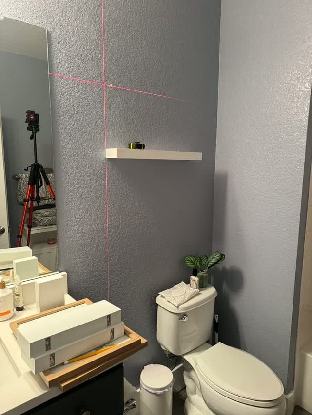 Floating shelves on a bathroom wall — before