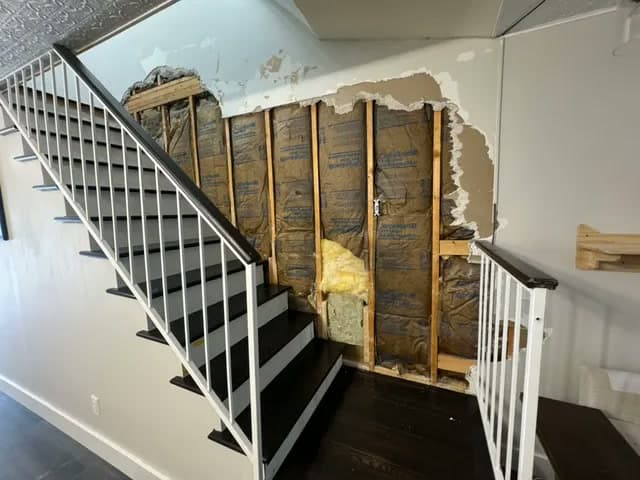Stairwell wall repair — before