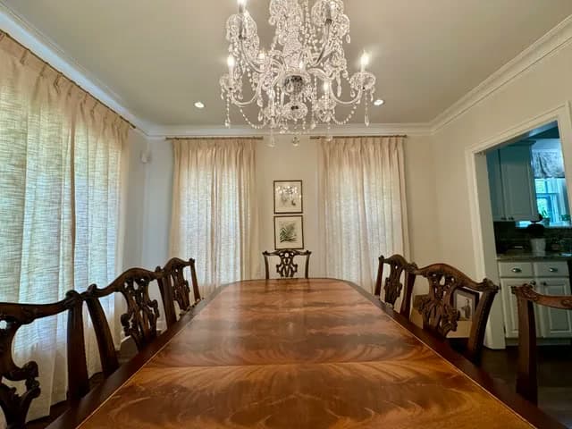 New curtains hung across the windows of a dining room